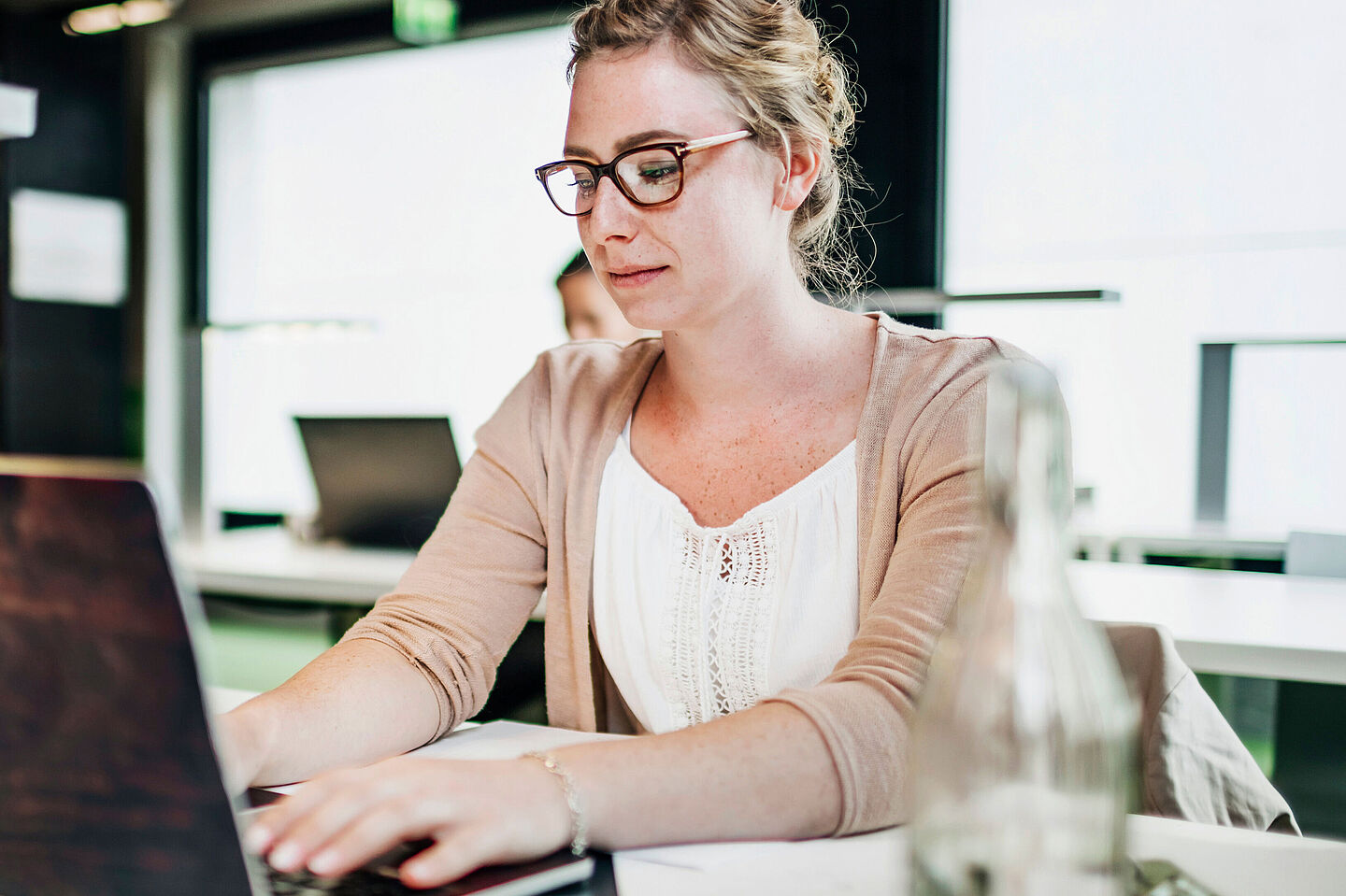 Person sitting at a desk using a laptop