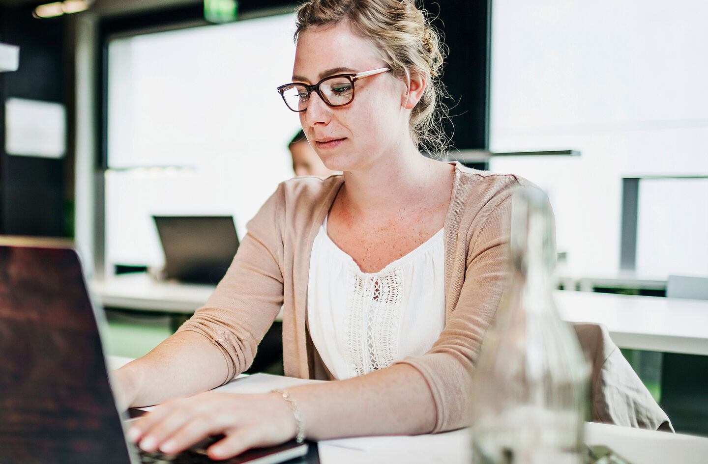 Person sitting at a desk using a laptop