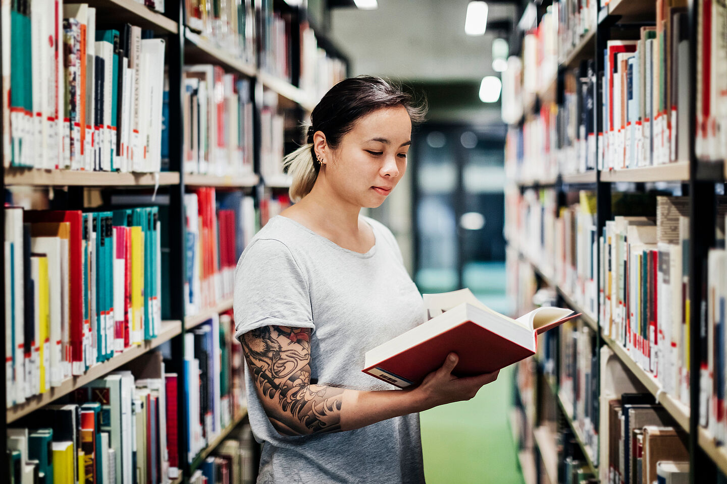 Student reading a book in the library