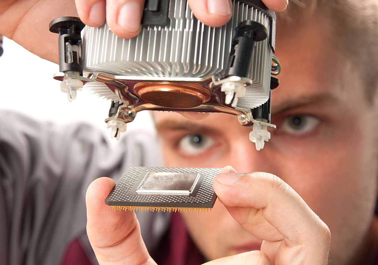 A student is holding a processor with cooling