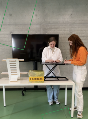 Zwei Studentinnen testen die mobilen Stehpulte in der Bibliothek.