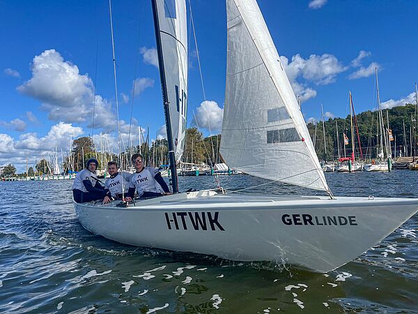 drei Menschen auf Segelboot auf See